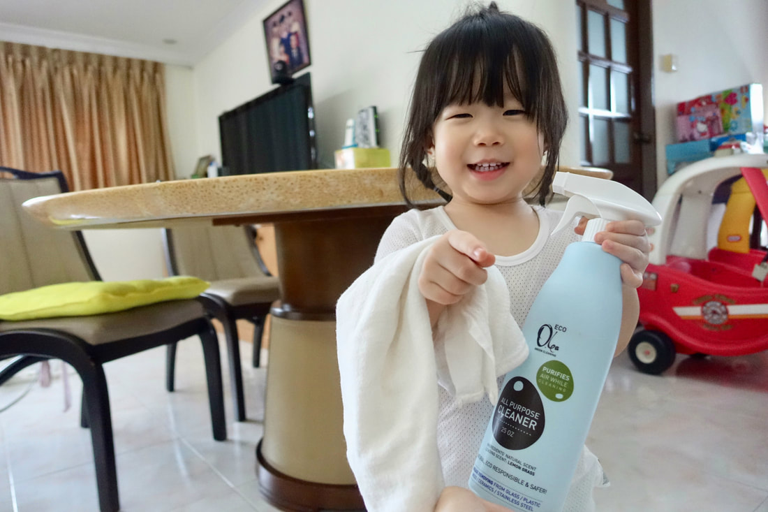 Mae the little cleaner, ready to get to work with a cloth and the Olea Essence Eco All-Purpose Cleaner!